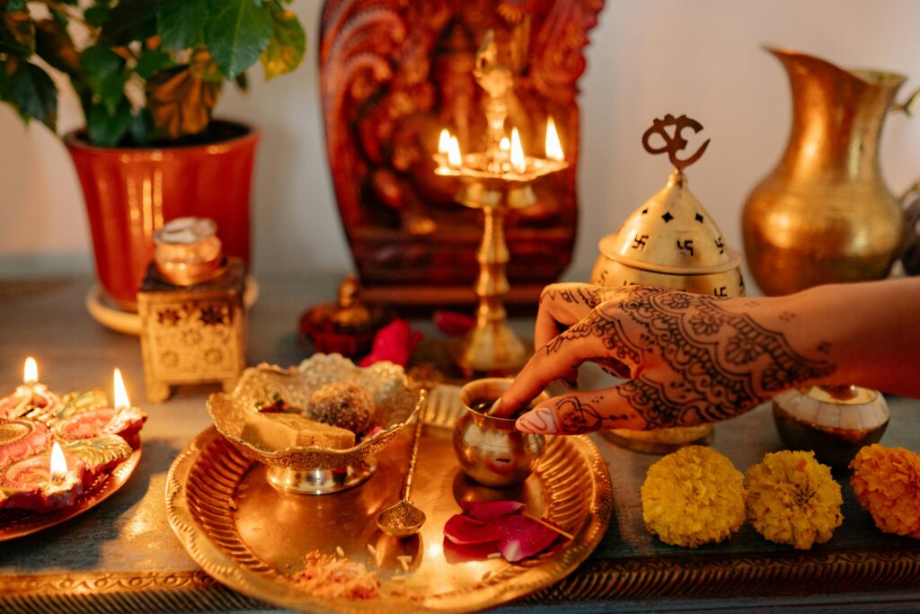 pexels-photo-8818750-8818750 A vibrant depiction of a traditional Indian Diwali ritual with decorated lights and cultural symbols.